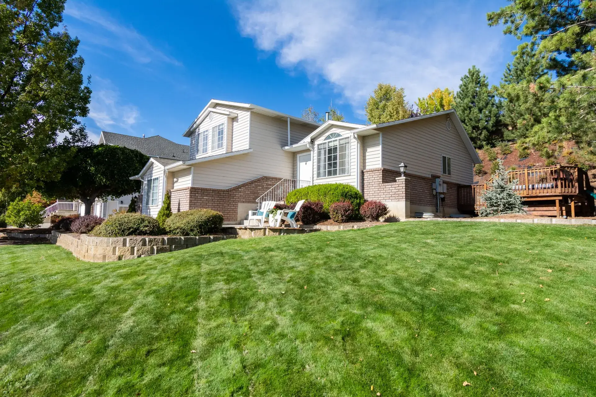Wide, freshly striped lawn in front of a home.