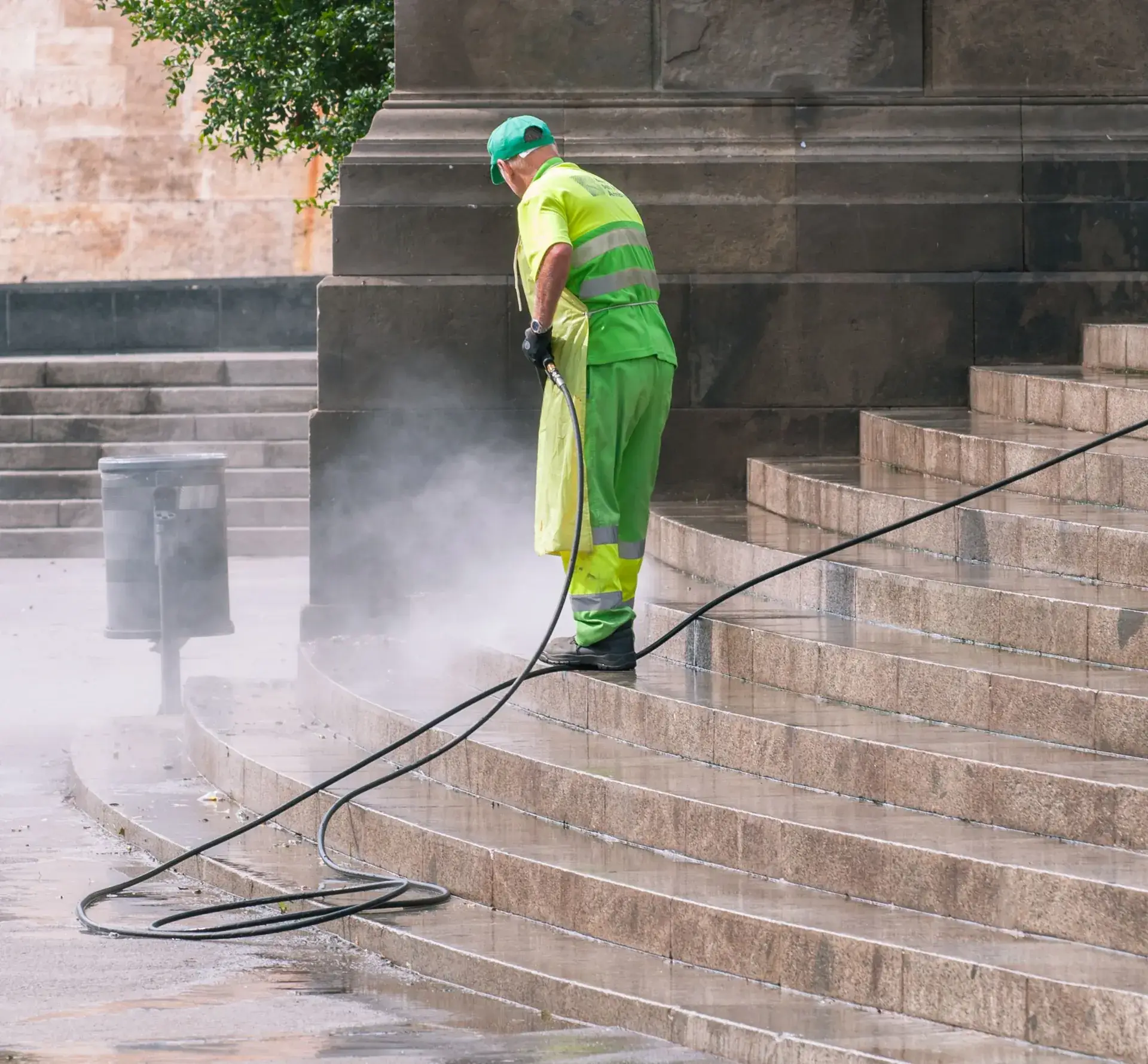 Stone steps being cleaned with a pressure washer.